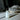 Bottle of ritual oil serum with white mica shimmer on a dark background