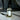 Glass dropper bottle of ritual oil with a white label on a marble surface