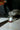 Dropper of oil pouring into a small glass bottle with a label that says attraction 
